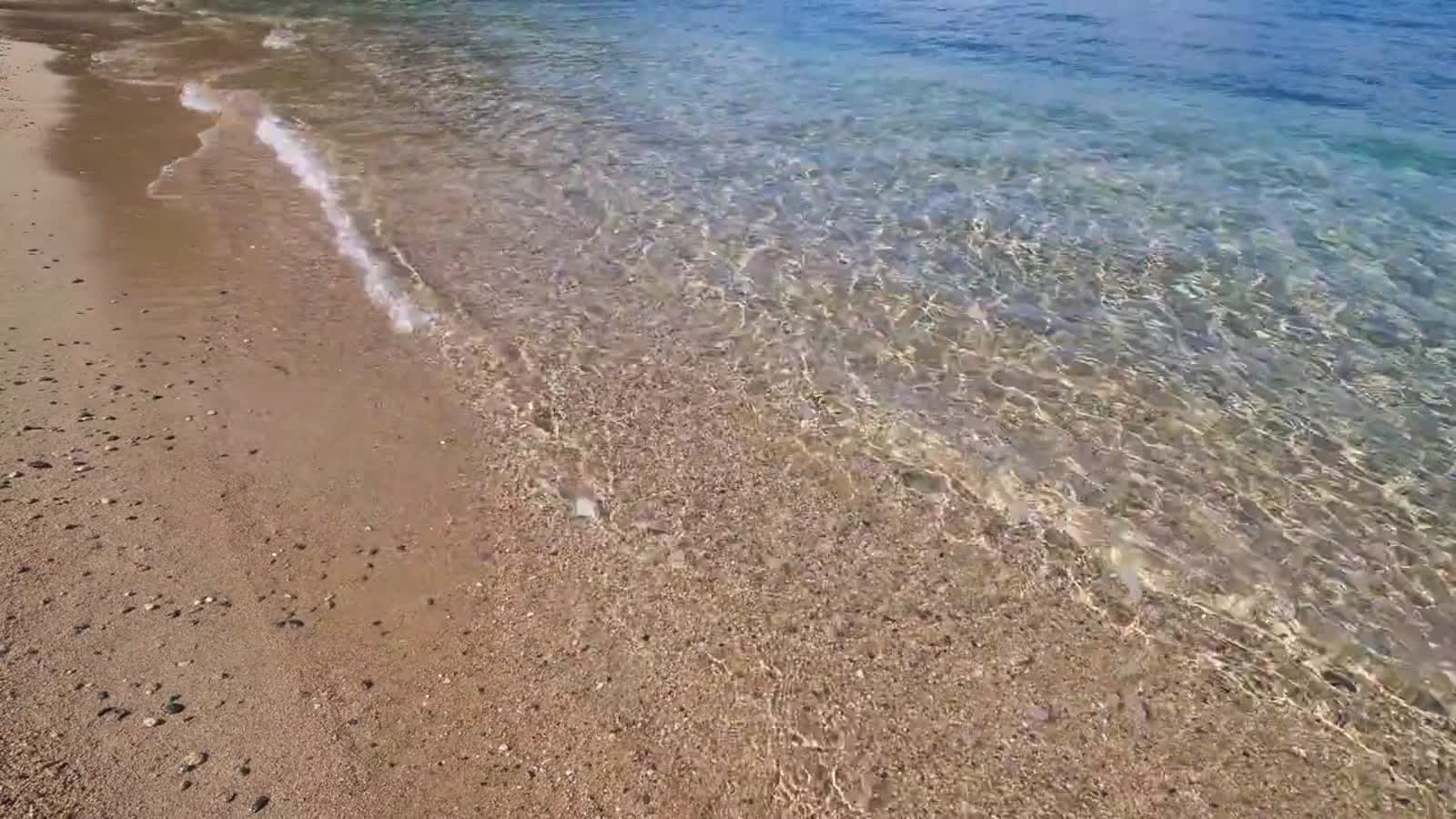 Clear water and golden sand at St Ives Bay